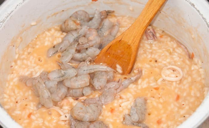 adding shrimp to the risotto